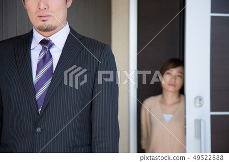 Wife sending out her husband at the entrance Wife sending out her husband at the entrance 49522888