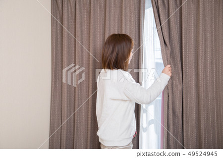 Woman watching the outside of the window Woman watching the outside of the window 49524945