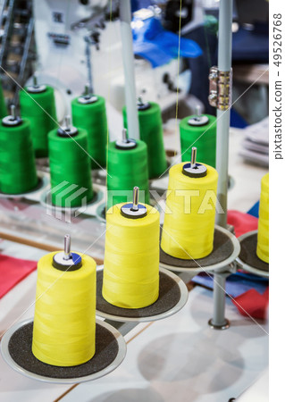 different color threads on the sewing machine  49526768