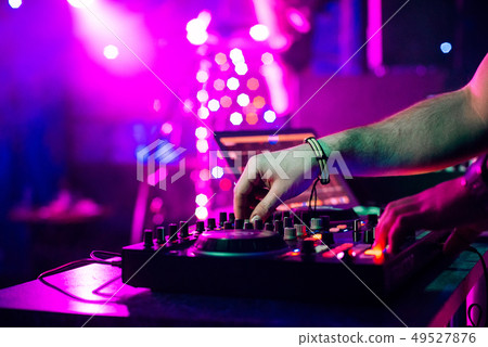 hands DJ mixing and playing music on a professional controller mixer hands DJ mixing and playing music on a professional controller mixer 49527876