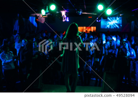 blurred silhouette of the singer on stage and crowds blurred silhouette of the singer on stage and crowds 49528094
