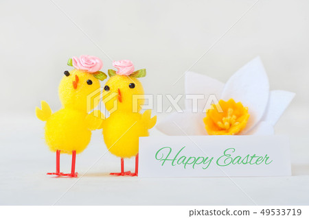 Two little yellow chicken with a congratulatory inscription - happy easter. 49533719