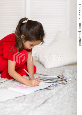 little child girl draws with pencils at home 49533804