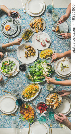 Mediterranean style dinner and human hands Mediterranean style dinner and human hands 49535006