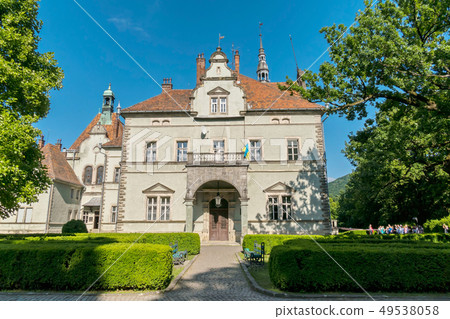 An ancient manor house with a roof from a once red An ancient manor house with a roof from a once red 49538058