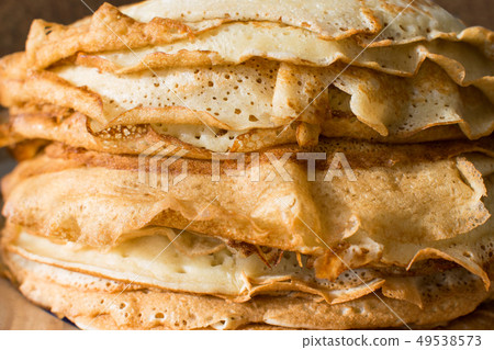 Stack of English pancakes on a round white plate 49538573