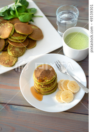 Dietary pancakes with spinach. Stack of pancakes 49539301