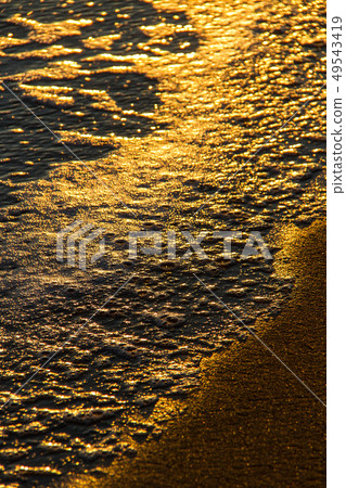 Colorful shapes of breaking waves on sandy shore 49543419