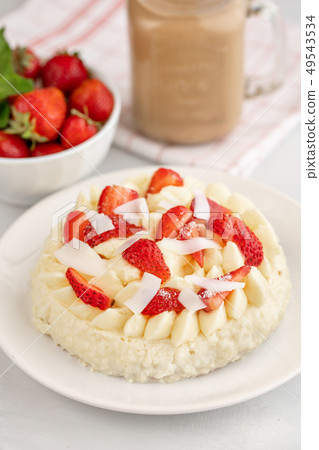 Delicate strawberry cheesecake with coconut. Delicious homemade cake with Fresh berries on light 49543534