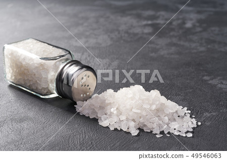 Sprinkle salt shakers on black stone background, Sprinkle salt shakers on black stone background, 49546063