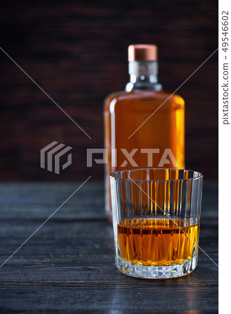 Whiskey on a black wooden tableSilhouette of a Whiskey on a black wooden tableSilhouette of a 49546602