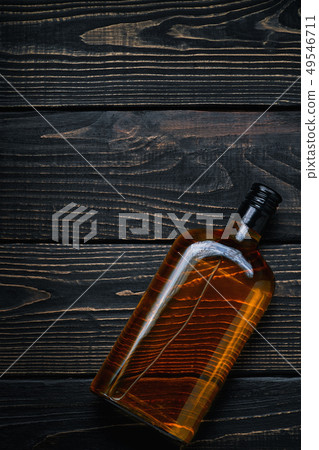 Bottle of whiskey on a black wooden table.Top Bottle of whiskey on a black wooden table.Top 49546711
