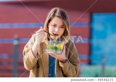 Young businesswoman with salad at urban city outdoor. Young businesswoman with salad at urban city outdoor. 49548215