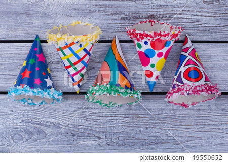 Flat lay party hats on wooden background. Flat lay party hats on wooden background. 49550652
