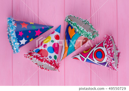 Decorated party hats on color background. Decorated party hats on color background. 49550729