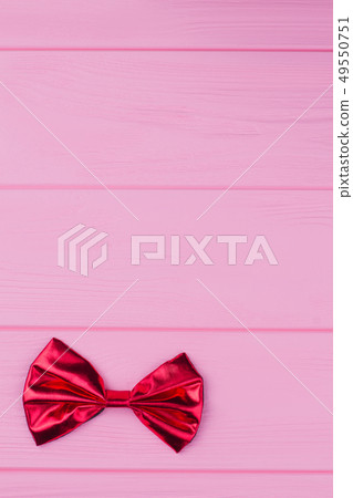 Red bow-tie on color background. 49550751