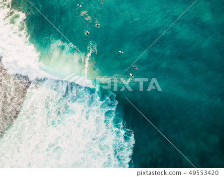 Aerial view of surfing at big waves Aerial view of surfing at big waves 49553420