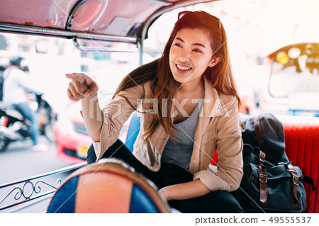 Young woman sitting at tuk tuk in Bangkok, Thailand 49555537