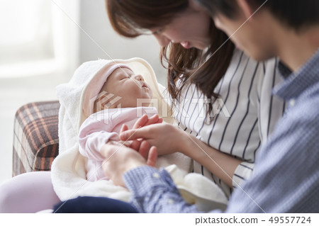A couple holding a baby 49557724