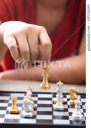 Hand of woman playing chess for business tactic Hand of woman playing chess for business tactic 49558045