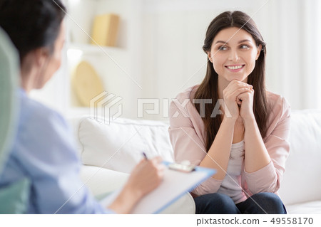 Smiling woman talking to wellness coach about motivation Smiling woman talking to wellness coach about motivation 49558170