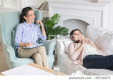 Young woman dreaming about new life at life counselor Young woman dreaming about new life at life counselor 49558875
