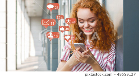 Blogger using phone with social media notification icons 49559127