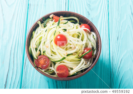 Zucchini pasta noodles with tomatoes . Healthy 49559192