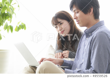 Couple looking at pc Couple looking at pc 49559526