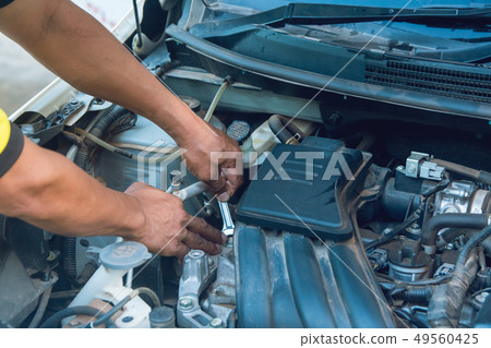 Car mechanic working with wrench in garage. Repair 49560425