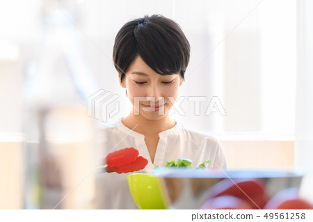 Kitchen woman cooking salad 49561258