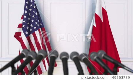 Flags of the United States and Bahrain at international meeting or negotiations press conference. 3D 49563789