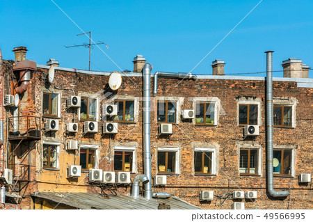 Air conditioners on a brick wall. 49566995