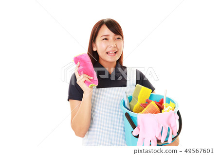 A smiling housewife with a cleaning tool 49567601