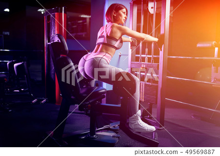 Fitness woman doing lunges exercises for leg muscle workout training in gym 49569887
