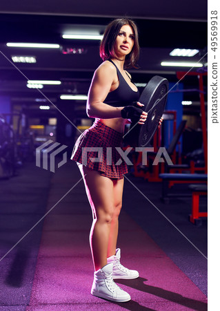 fitness girl exercising with barbell in gym fitness girl exercising with barbell in gym 49569918