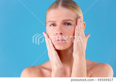 Close up portrait of gorgeous beautiful and good-looking young woman with flawless skin. She is Close up portrait of gorgeous beautiful and good-looking young woman with flawless skin. She is 49569927