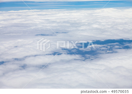 Clouds, sky and ground, looking from the plane. 49570035