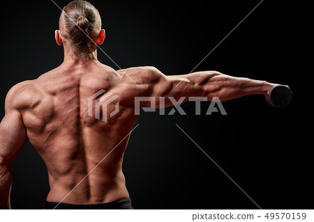 Athletic man posing. Photo of man with perfect physique on black background. Back view. Strength and Athletic man posing. Photo of man with perfect physique on black background. Back view. Strength and 49570159