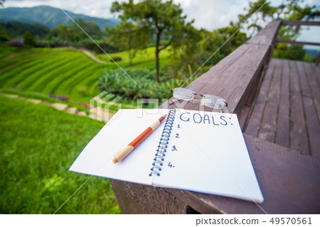 Business plan and goal. Writing on the white paper Business plan and goal. Writing on the white paper 49570561