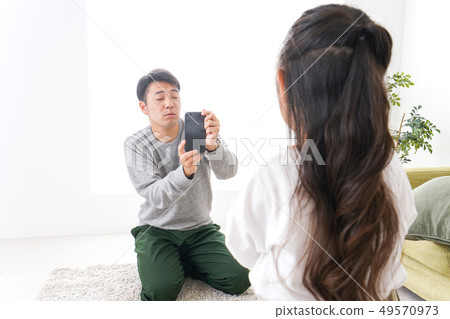 Dad taking pictures of children 49570973