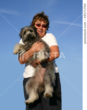 Pyrenean sheepdog and senior woman Pyrenean sheepdog and senior woman 49571704