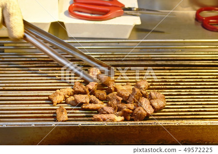 grilled dice beef cooking on gridiron street food  49572225