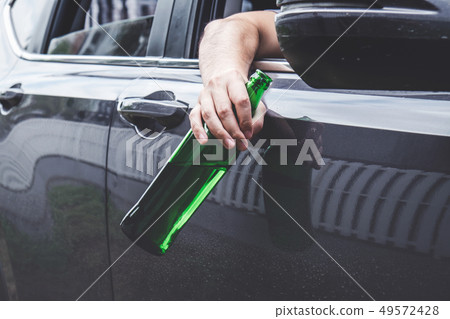 Close up of bottle, Young asian man drives a car with drunk a bo 49572428