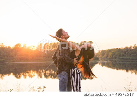 Kizomba, bachata, zouk and latin social dance concept - Man and woman dancing over nature background 49572517