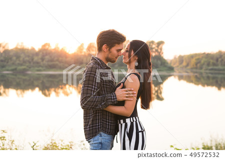 Relationship, love and nature concept - Close up portrait of attractive woman and handsome man 49572532
