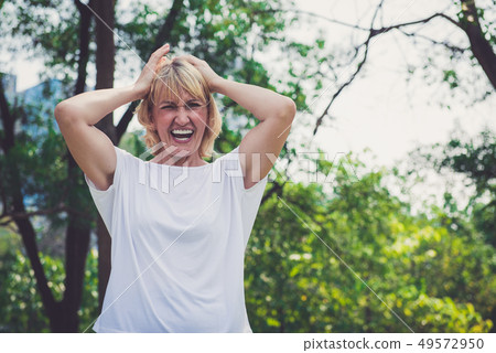 Old woman get mad and screaming in the park 49572950