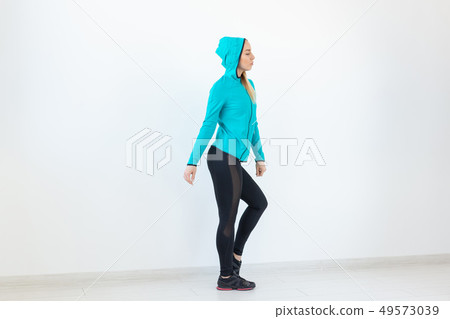 People, sport and fitness concept - attractive young woman in sportswear posing on white background People, sport and fitness concept - attractive young woman in sportswear posing on white background 49573039