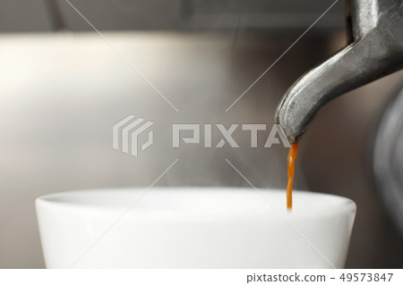 Close-up of freshly brewed coffee is poured from a 49573847