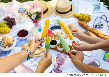 Woman hands hold colorful ice-cream sticks at Woman hands hold colorful ice-cream sticks at 49573851